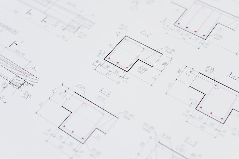 High-resolution close-up of detailed architectural blueprints showcasing precision design layouts.